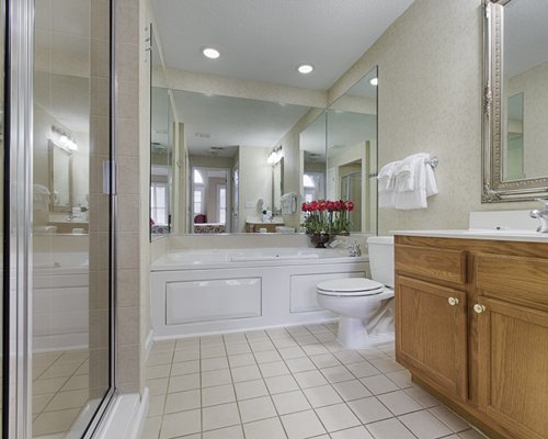A bathroom with shower bathtub and sink vanity.