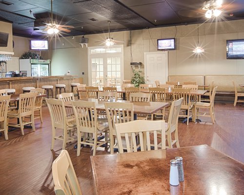 A well furnished wooden common dining area with television.