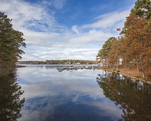 A lake view of the Fairfield Plantation Resort surrounded by wooded area.
