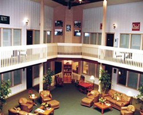 Indoor view of a large open reception area with a lounge area on the ground floor.