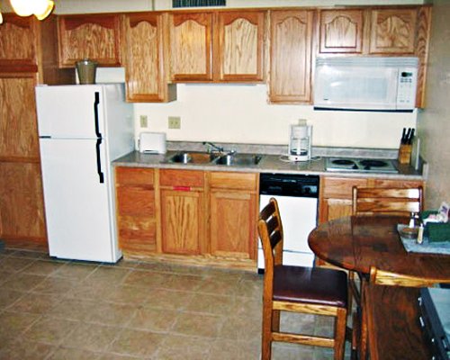 A well equipped kitchen with a dining table.