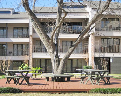 Picnic area alongside multi story suites with private balconies.