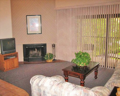 Furnished living room with television and a balcony.