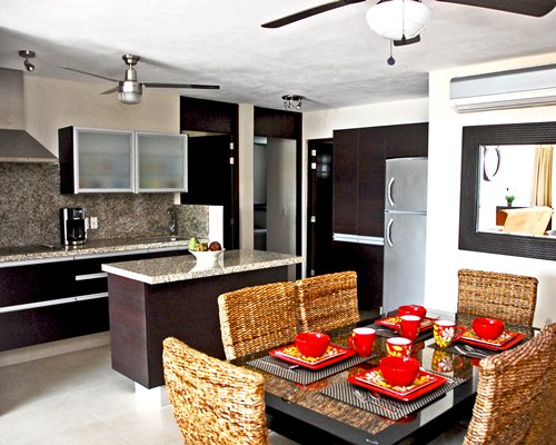 An open plan kitchen and glass top dining area.