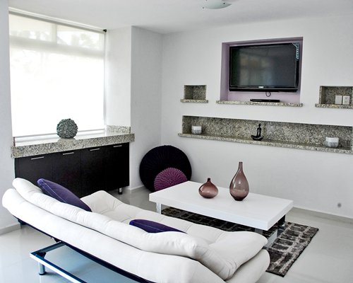 A well furnished living room with a television and an outdoor view.