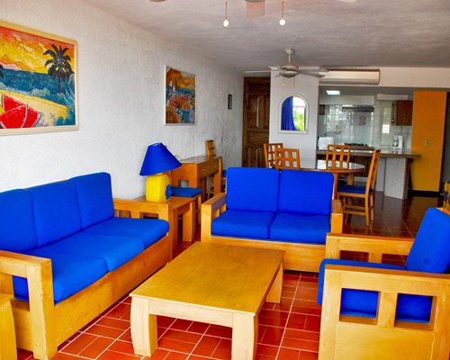 An open plan living room with kitchen and dining area.