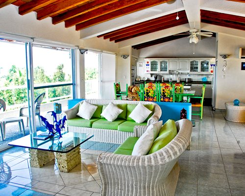 An open plan living dining and kitchen area with an outside view.