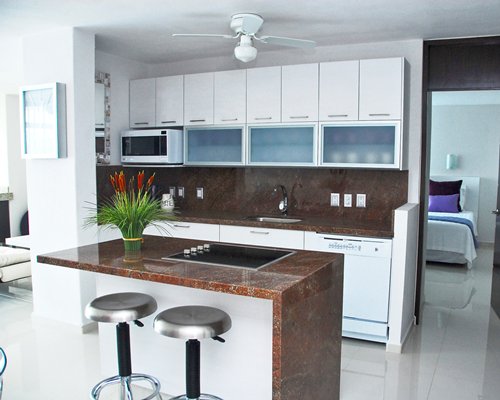 A well furnished kitchen with a breakfast bar.