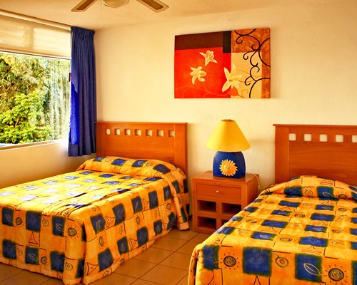 A well furnished living room with two twin beds.