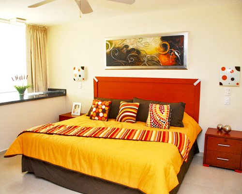 A well furnished bedroom with a king sized bed and an outdoor view.