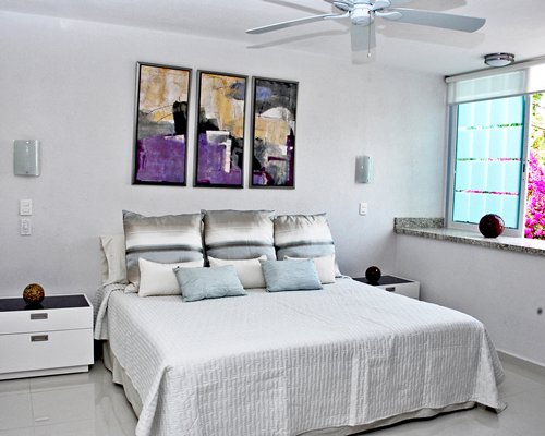 A furnished living room with king size bed.