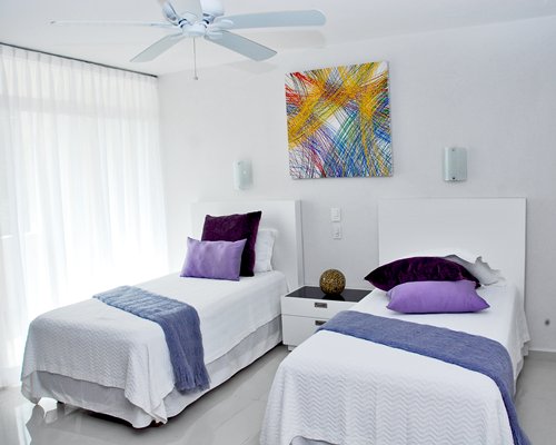 A furnished bedroom with two single beds.