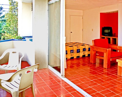 An open plan furnished living room with balcony.