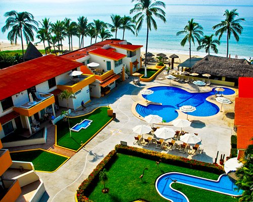 An aerial view of Suites Costa Dorada with an outdoor swimming pool facing the ocean.