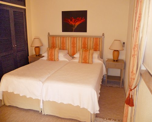 A furnished bedroom with two twin beds.
