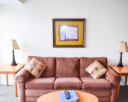 A well furnished living room with sofa queen bed and an outside view.