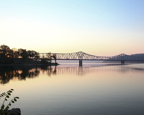 A lake view with truss bridge.