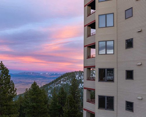 A dusk view of Ridge Tahoe resort in a wooded area.