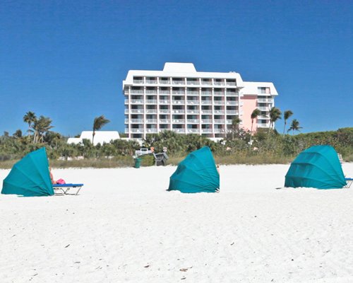 A view of multi story units and camping tents on the beach.