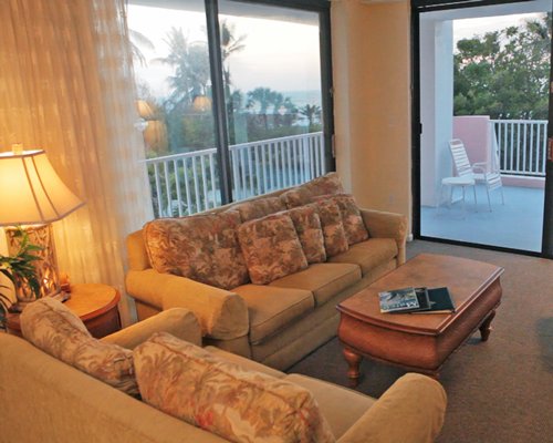 A well furnished living room with a queen pull out sofa and a balcony.