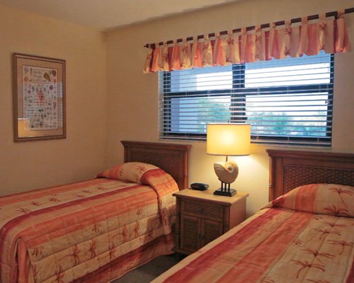 A furnished bedroom with two twin beds.