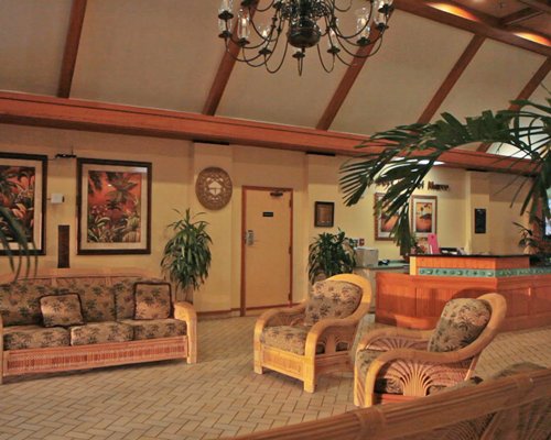The reception area of The Surf Club of Marco with indoor plants.
