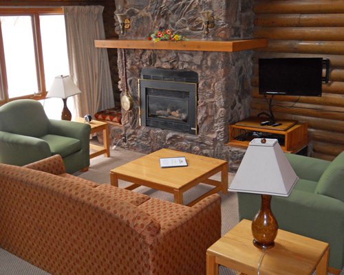 Furnished living room with television fireplace and outside view.