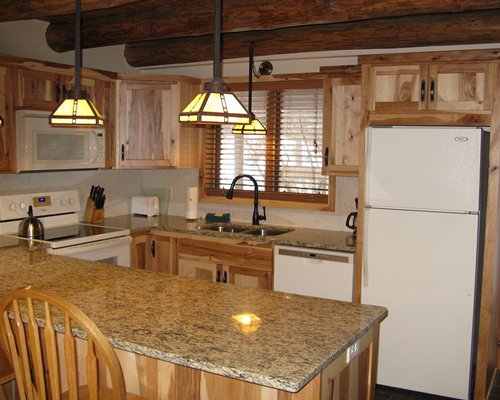 An open plan kitchen with stove and dishwasher.