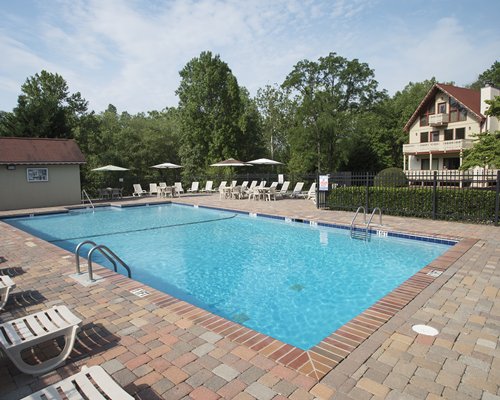 Outdoor swimming pool with chaise lounge chairs.