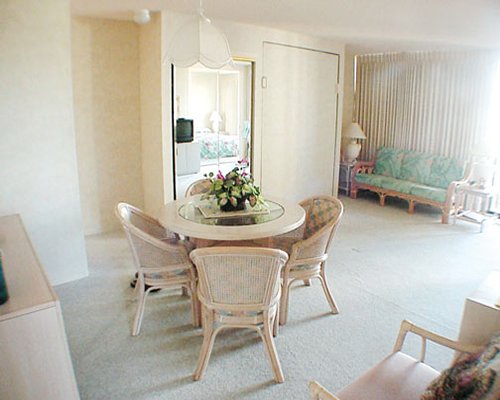 A well furnished living room with open plan dining area.