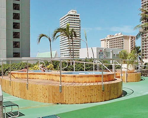 A view of an outdoor swimming pool alongside multi story buildings.