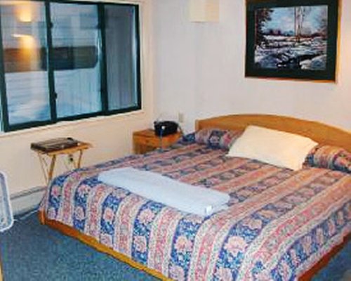 Furnished bedroom with king bed.
