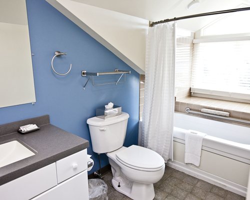 A bathroom with shower and bathtub with closed vanity.