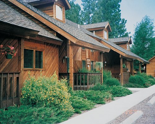 A street view of multiple resort condos surrounded by a wooded area.
