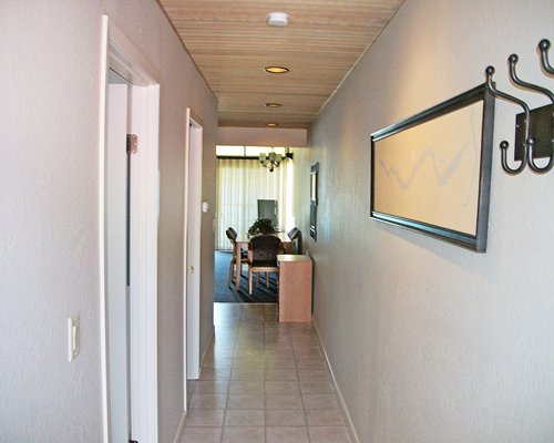 A corridor with painting and wall hanger.