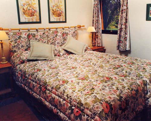 A well furnished bedroom with an exterior view.