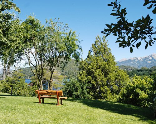 An outdoor picnic area surrounded by lawns and trees.