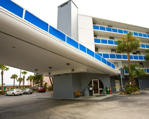 Exterior view of Sea Club IV resort with car parking.