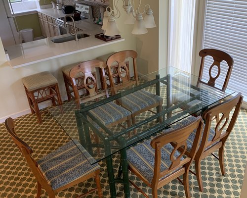 An open plan kitchen with dining area and outside view.