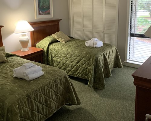 A well furnished bedroom with two double beds.