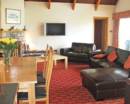 Furnished living room with open plan dining area and outside view.