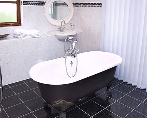 A bathroom with shower and bathtub.