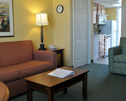 A well furnished living room with a view of the kitchen.