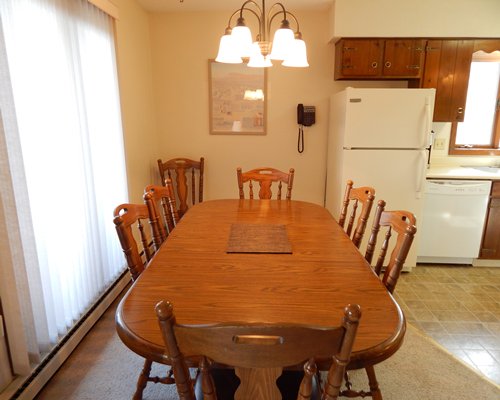 An open plan wooden themed dining room with a breakfast bar.
