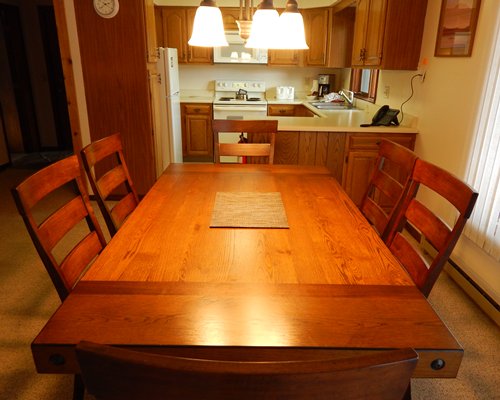 An open plan kitchen with stove and refrigerator.