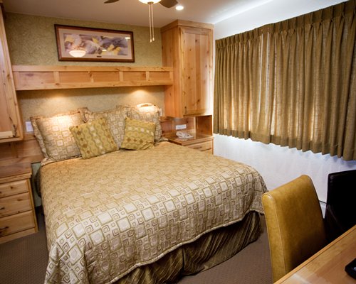 A furnished bedroom with a queen bed.