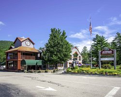 An aerial view of Attitash Mountain Village resort covered by snow.