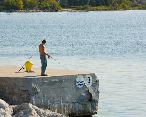 A man fishing with a fishing rod in the lake.