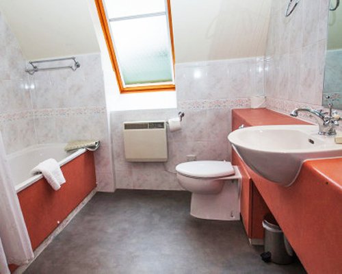 A bathroom with shower bathtub and a single sink vanity.