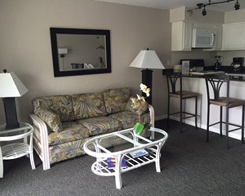 Furnished bedroom with two twin beds and outside view.